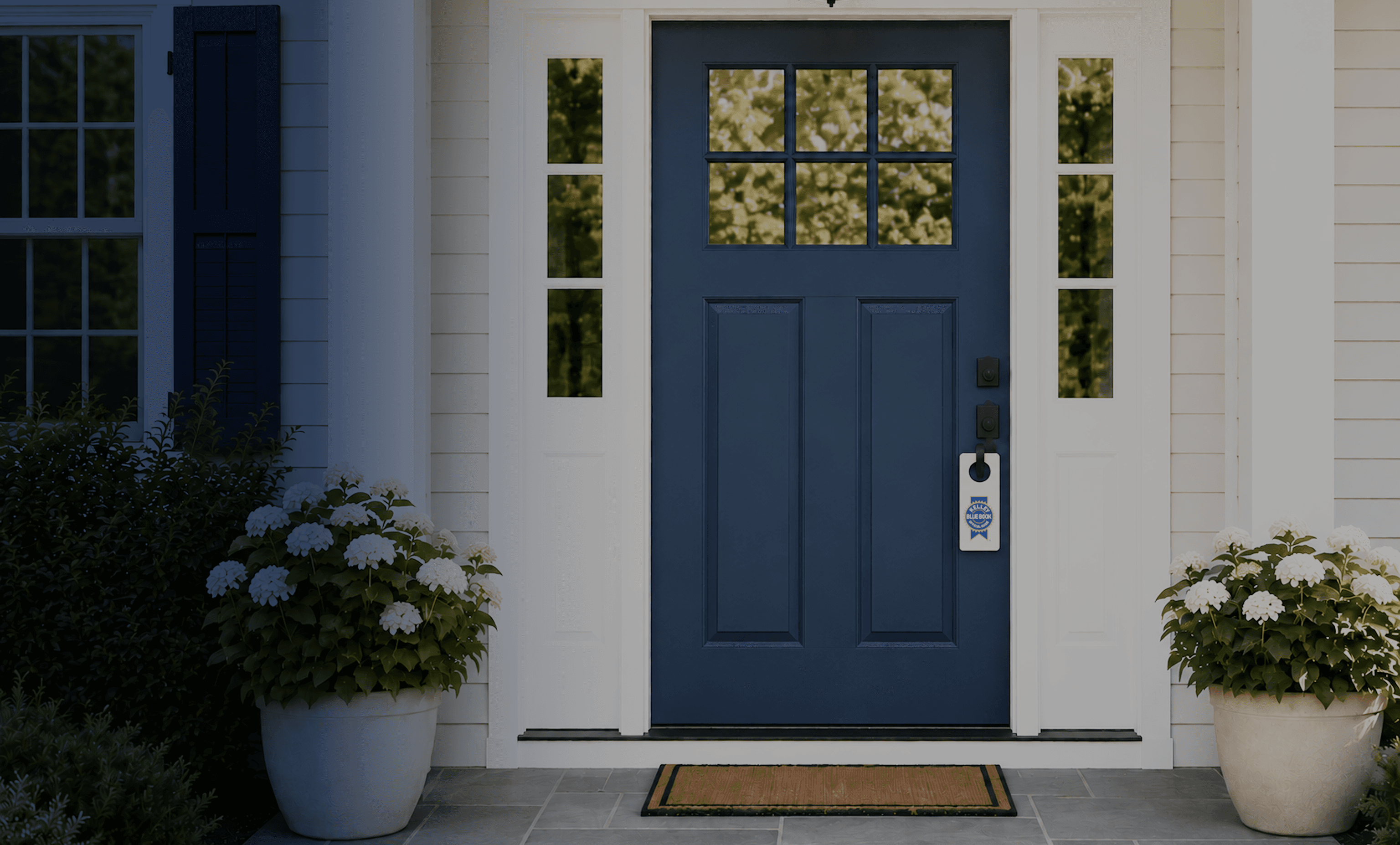 A home with a Kelley Blue Book Homes for-sale sign in the front yard
