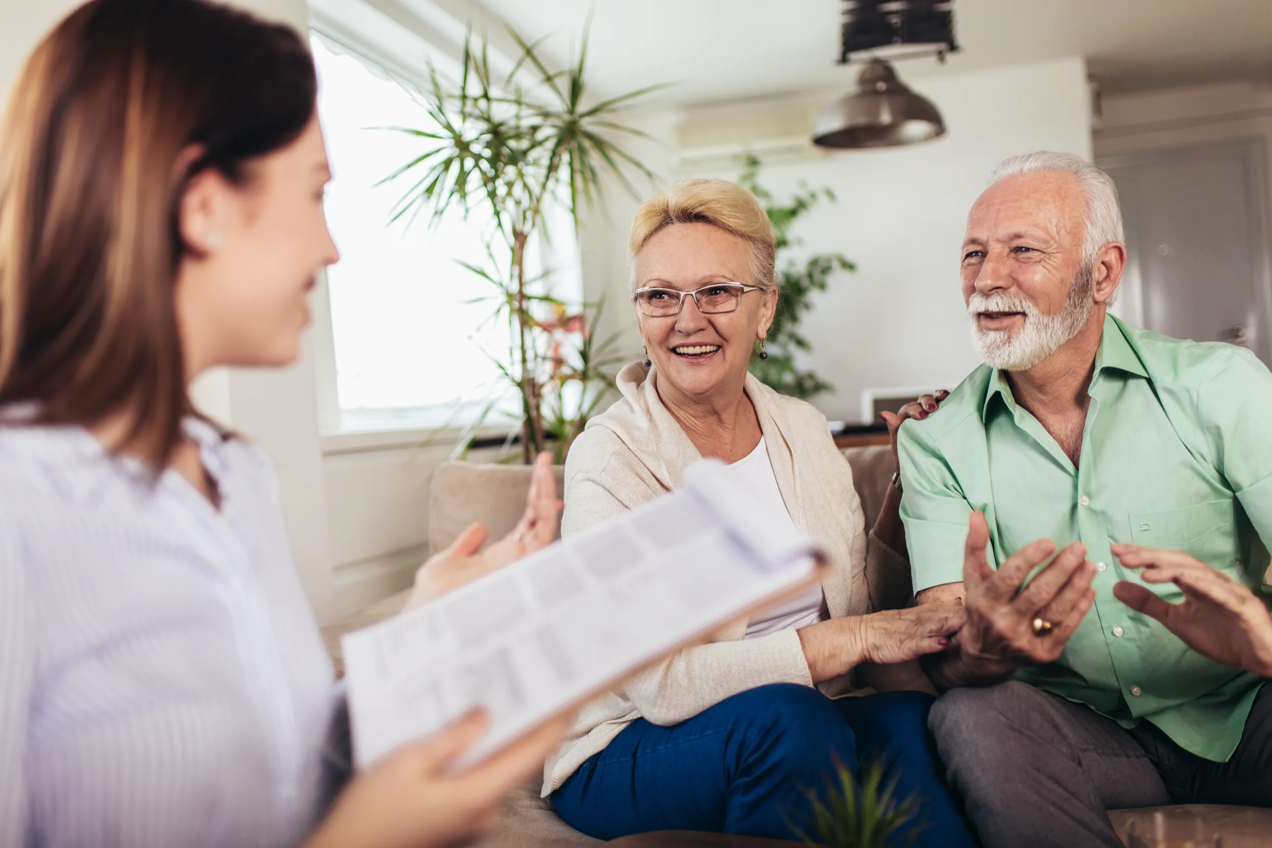 Advisor going over documents with a smiling couple
